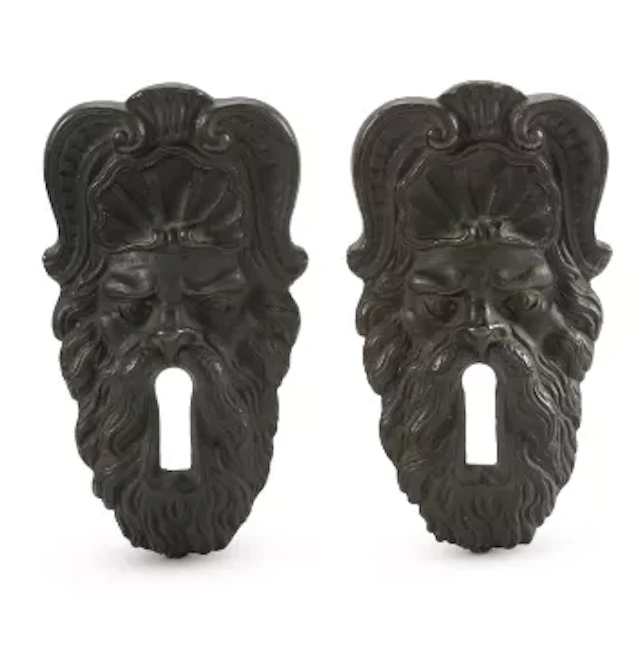 A PAIR OF BRONZE MASK ESCUTCHEONS, ITALIAN, PROBABLY FLORENCE, 18TH CENTURY
