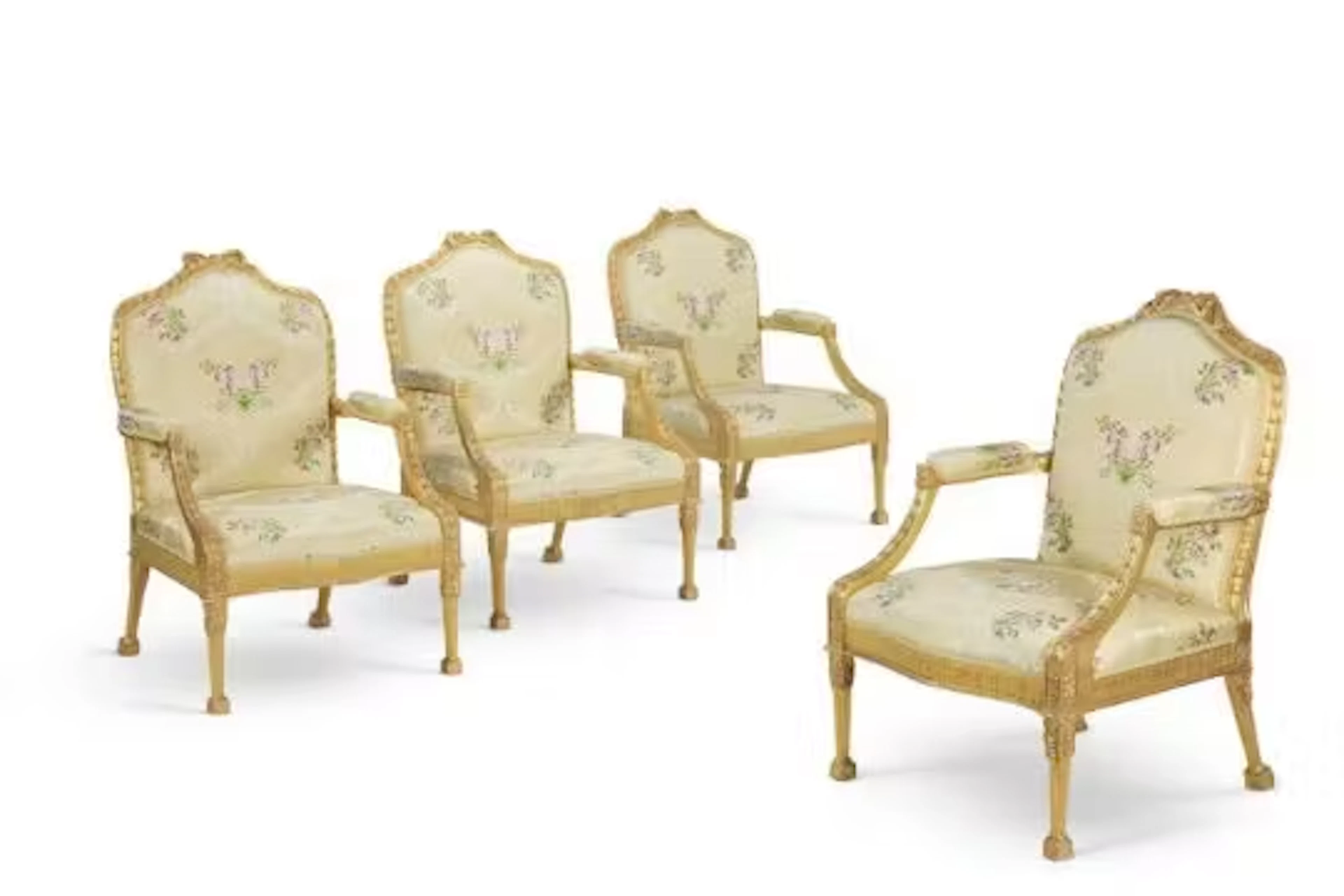 ‡ A SET OF FOUR GEORGE III GILTWOOD OPEN ARMCHAIRS, ATTRIBUTED TO JOHN LINNELL