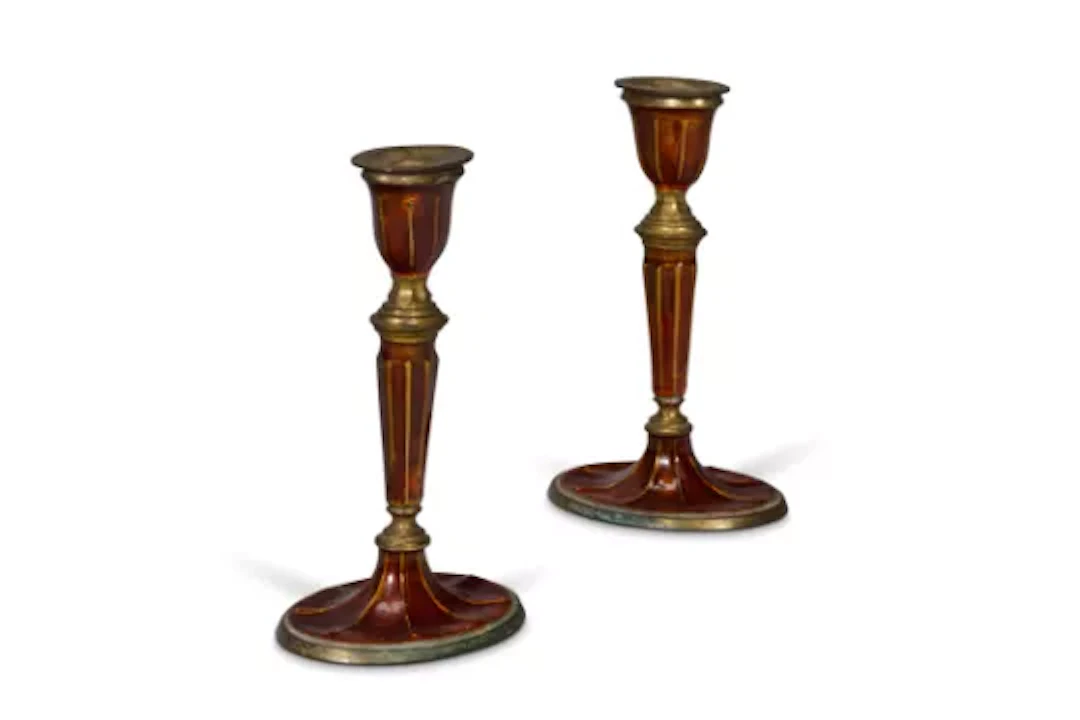 A PAIR OF ORANGE ENAMELED BRASS CANDLESTICKS, INDIAN, EARLY 20TH CENTURY