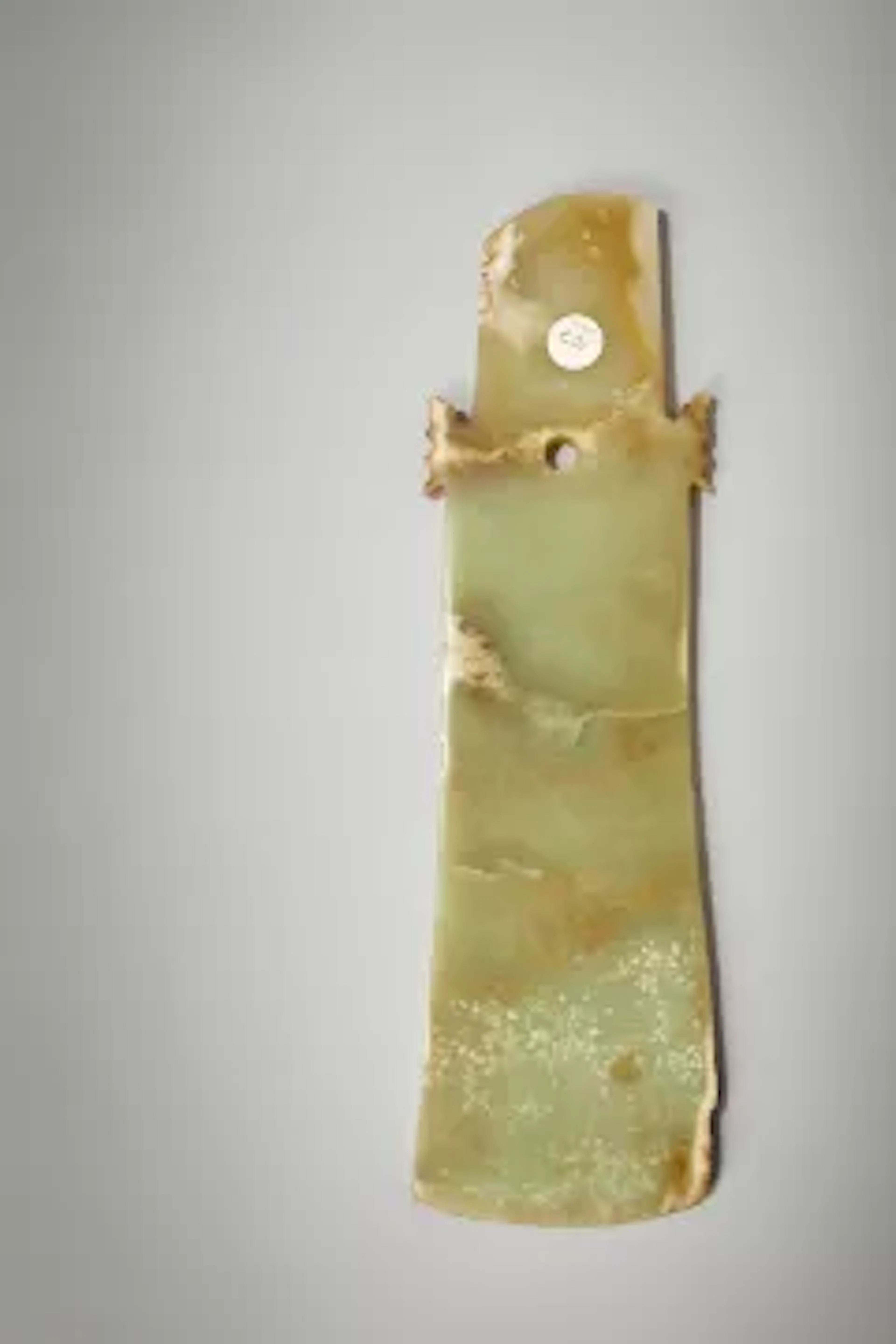 A Chinese large celadon jade ceremonial axe, qi, Neolithic period
