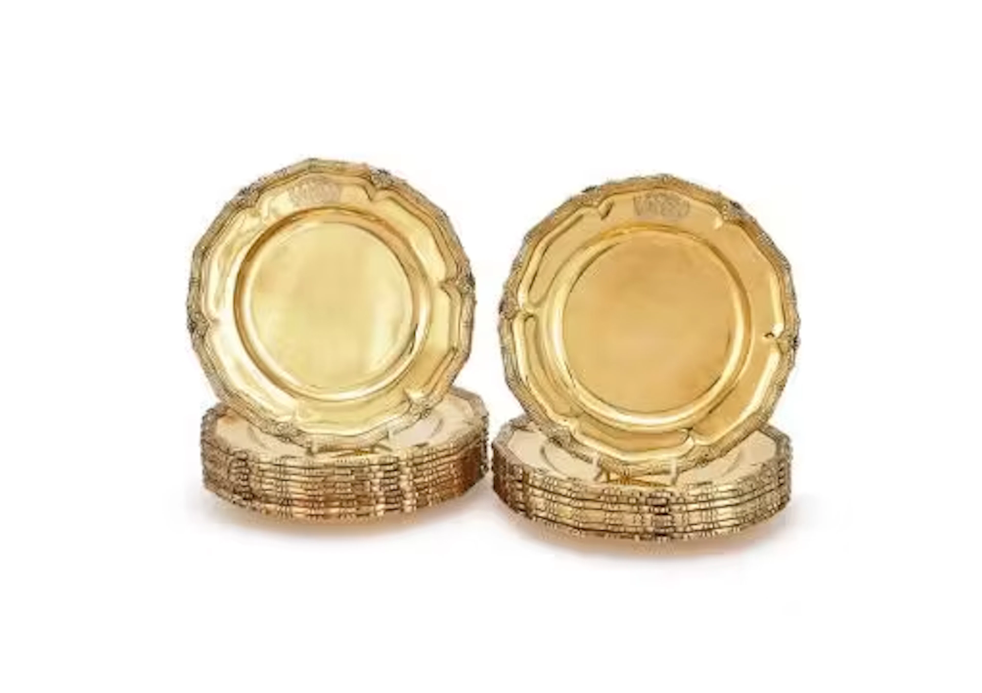 A SET OF EIGHTEEN SILVER GILT SHAPED CIRCULAR PLATES