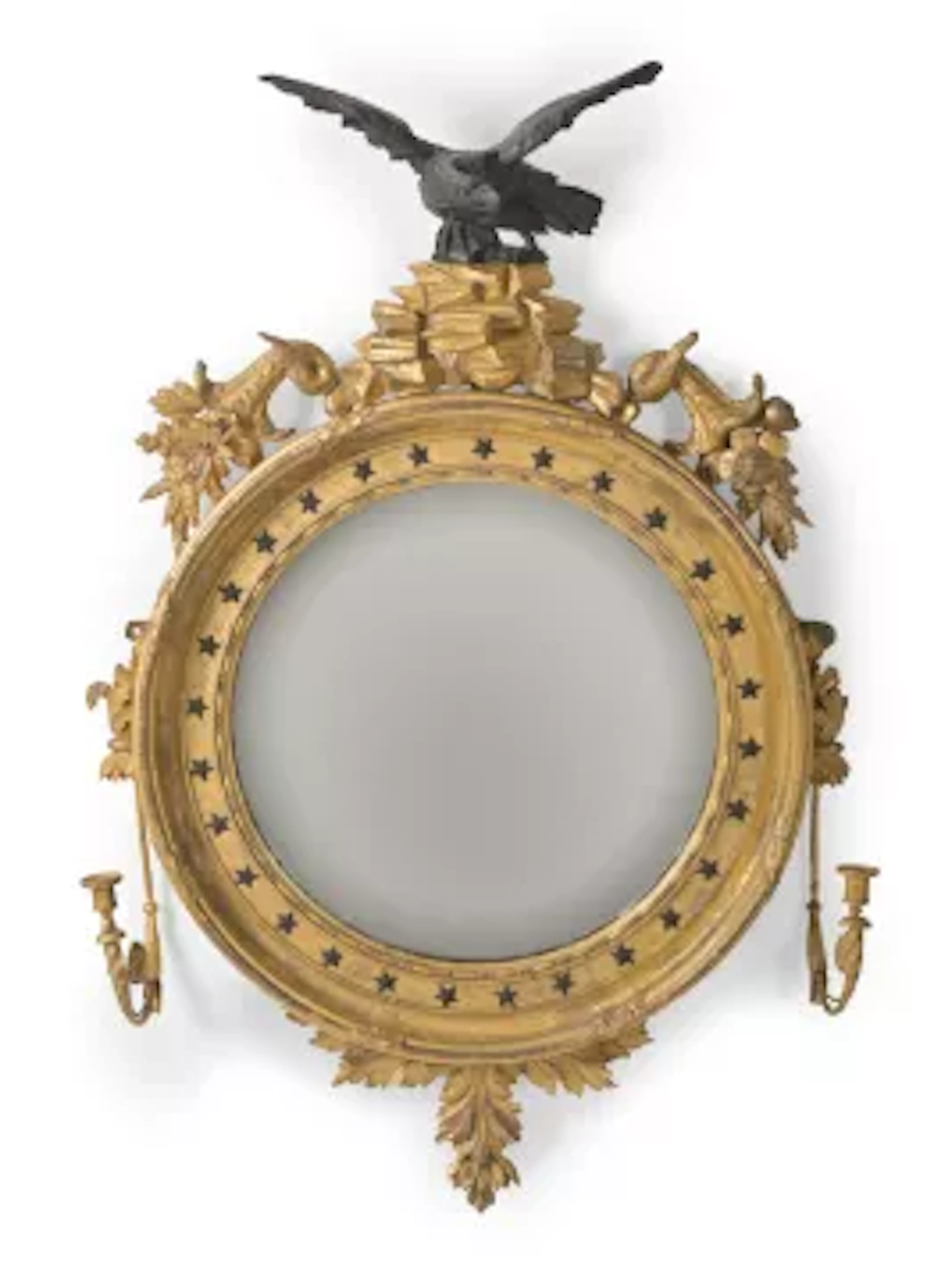 A REGENCY GILTWOOD AND EBONISED CONVEX GIRANDOLE MIRROR, IN THE MANNER