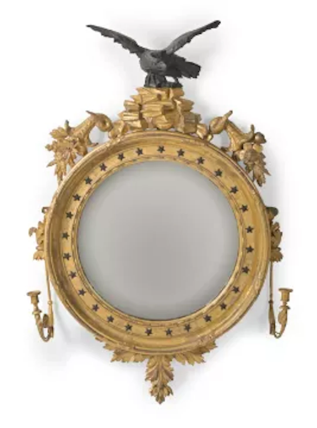 A REGENCY GILTWOOD AND EBONISED CONVEX GIRANDOLE MIRROR, IN THE MANNER