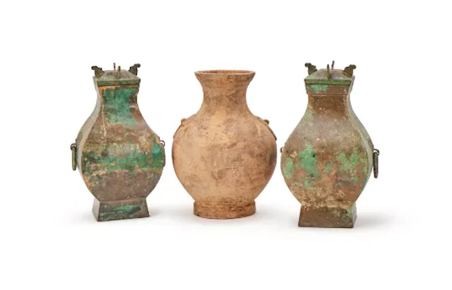 A pair of Han style bronze vases and covers, fanghu