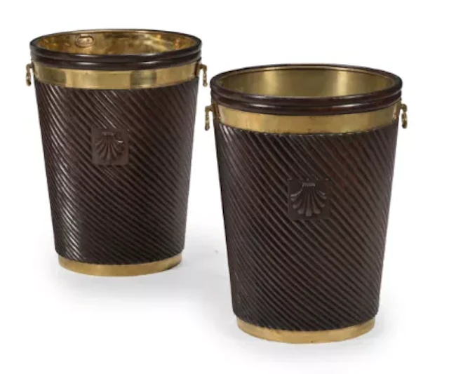 A LARGE PAIR OF CARVED MAHOGANY AND BRASS BOUND BUCKETS, IN IRISH