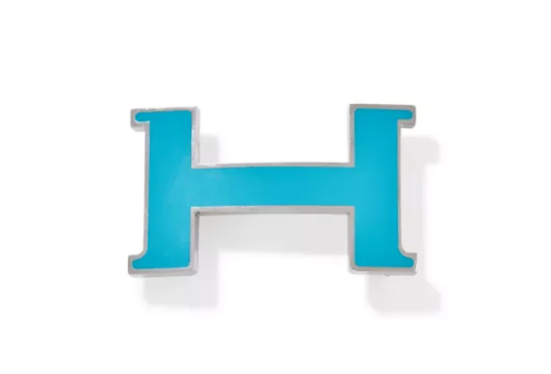 HERMÈS, A STAINLESS STEEL AND BLUE LACQUER H BELT BUCKLE