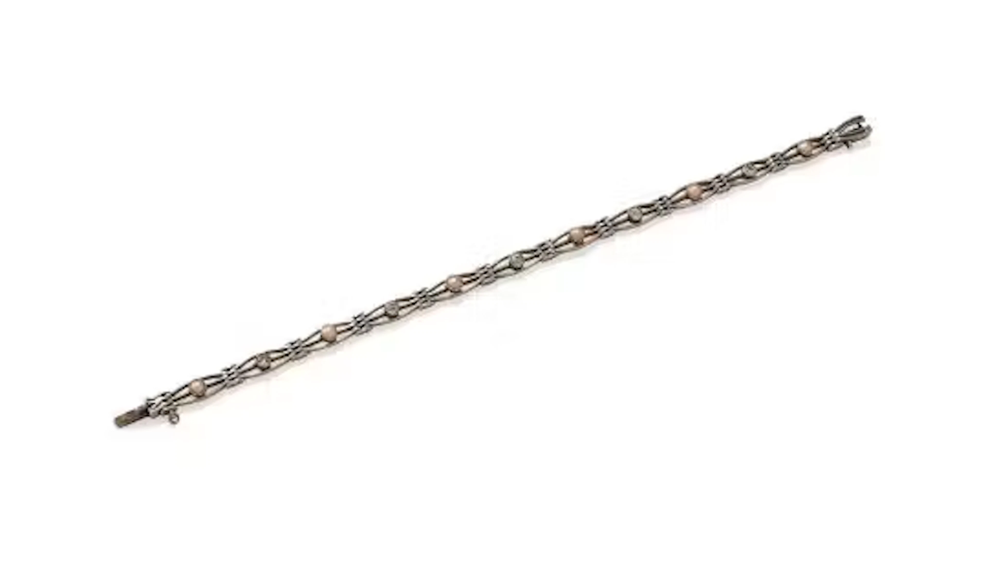 AN EARLY 20TH CENTURY DIAMOND AND HALF PEARL BRACELET