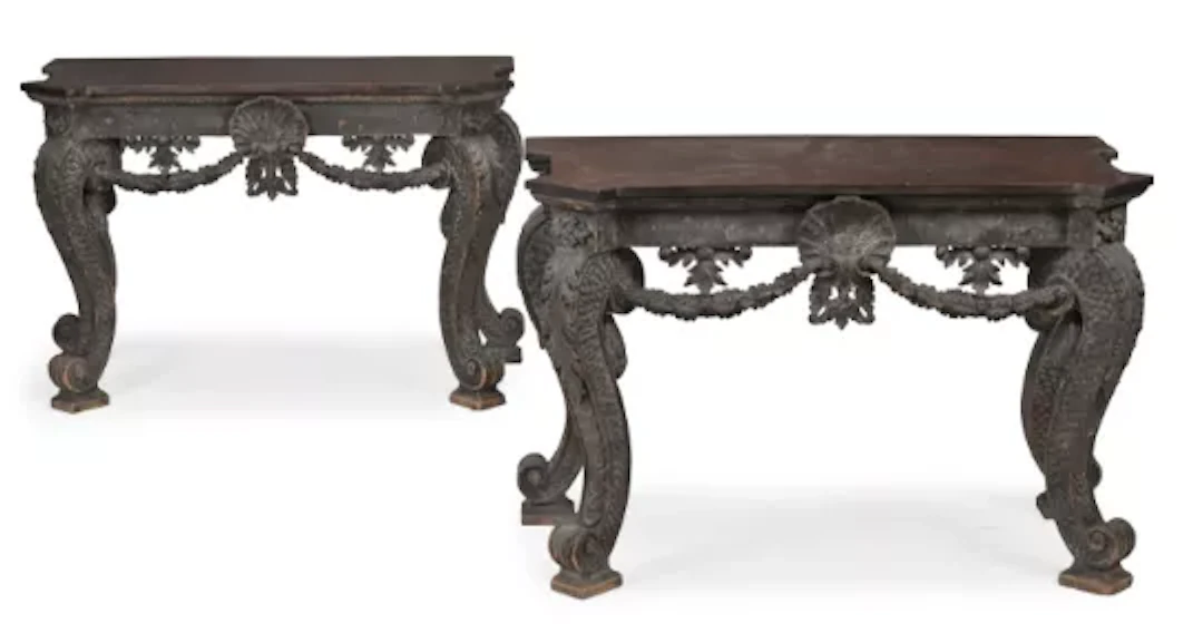 A PAIR OF CARVED WOOD AND EBONISED CONSOLE TABLES, IN THE MANNER OF