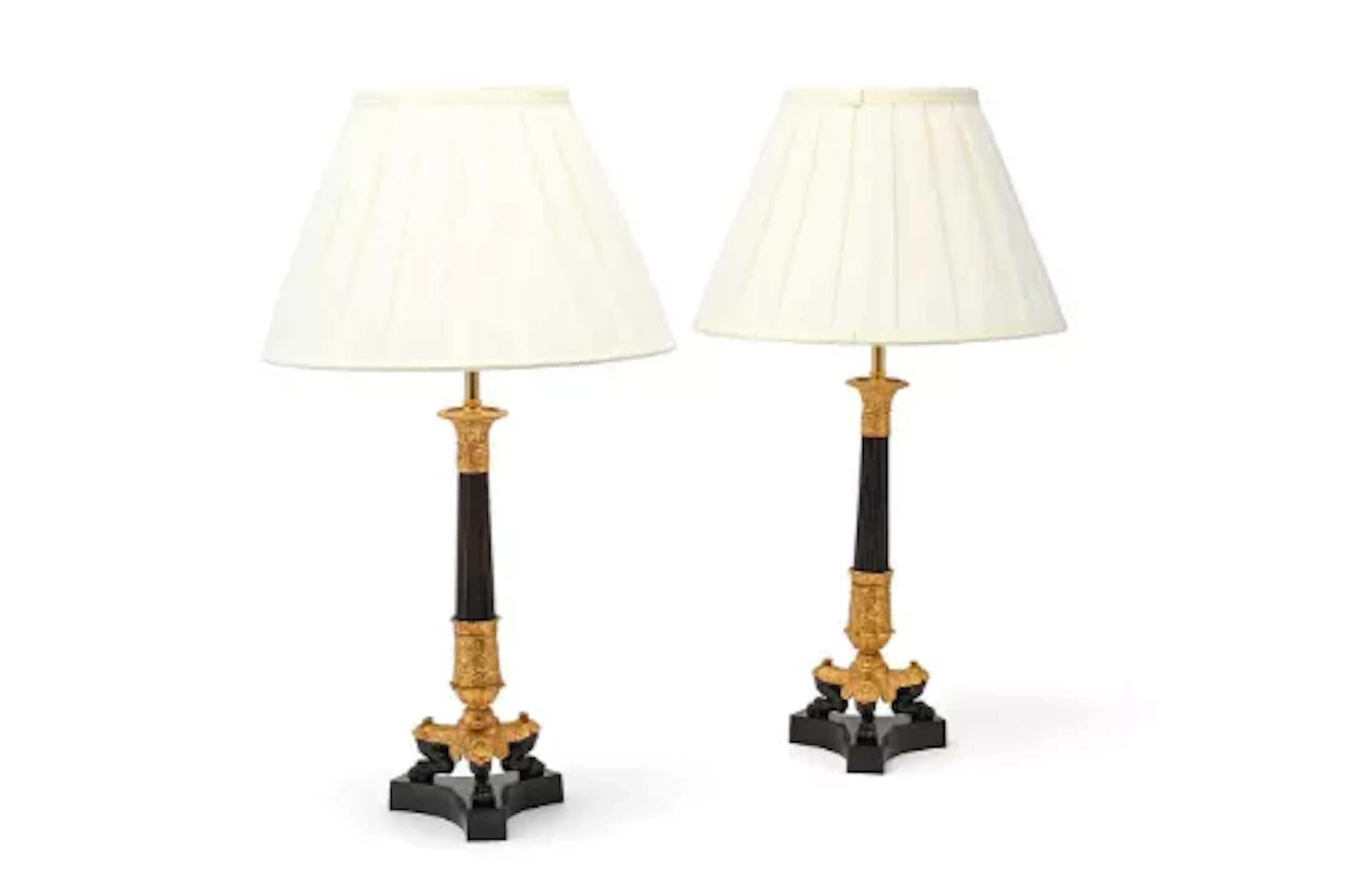 A PAIR OF GILT AND PATINATED BRONZE CANDLESTICK TABLE LIGHTS, EARLY