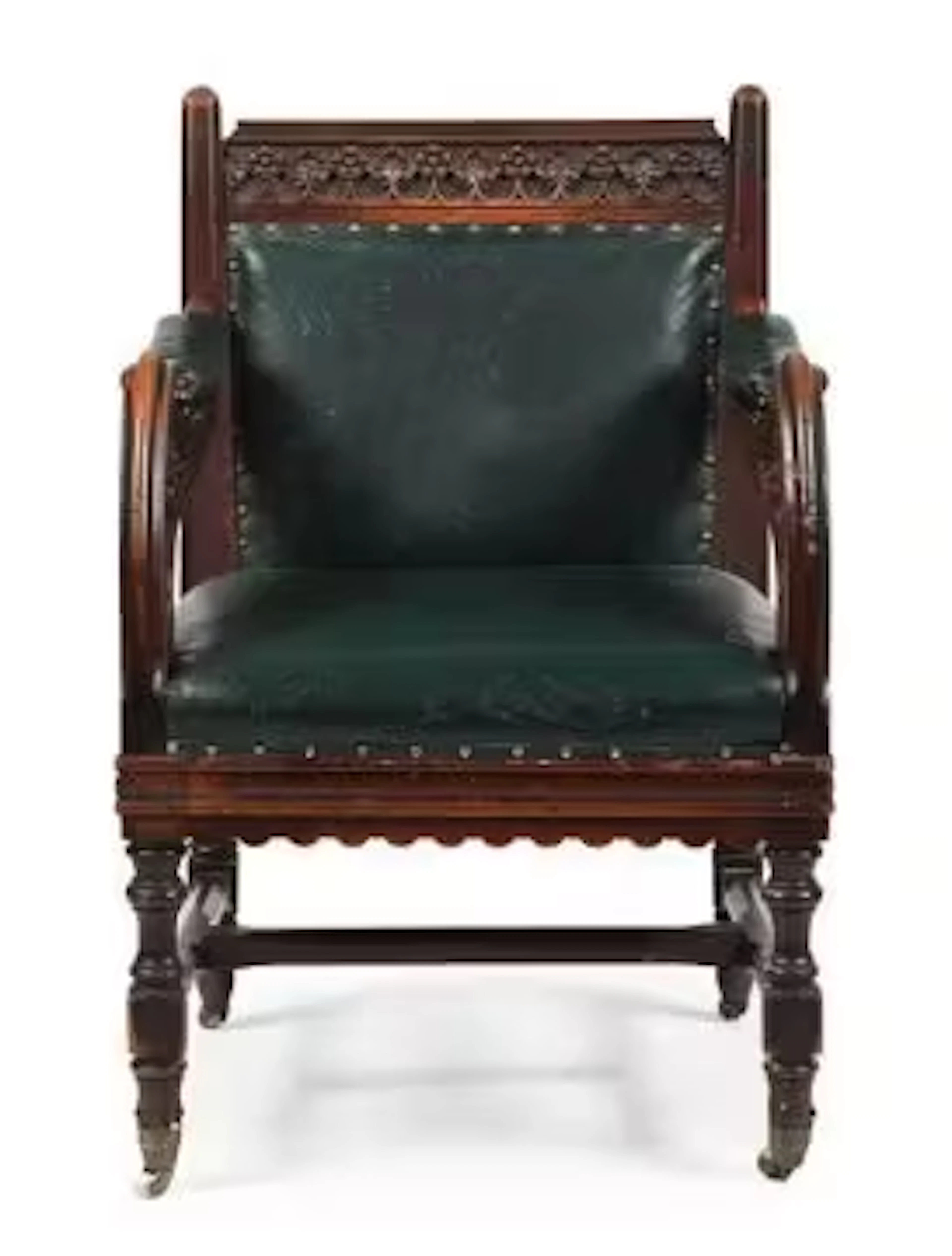 A VICTORIAN CARVED OAK AND LEATHER UPHOLSTERED ARMCHAIR, IN GOTHIC