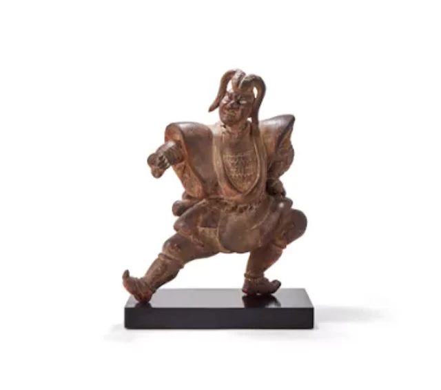 A Japanese carved hinoki wood figure of a kabuki actor striking a
