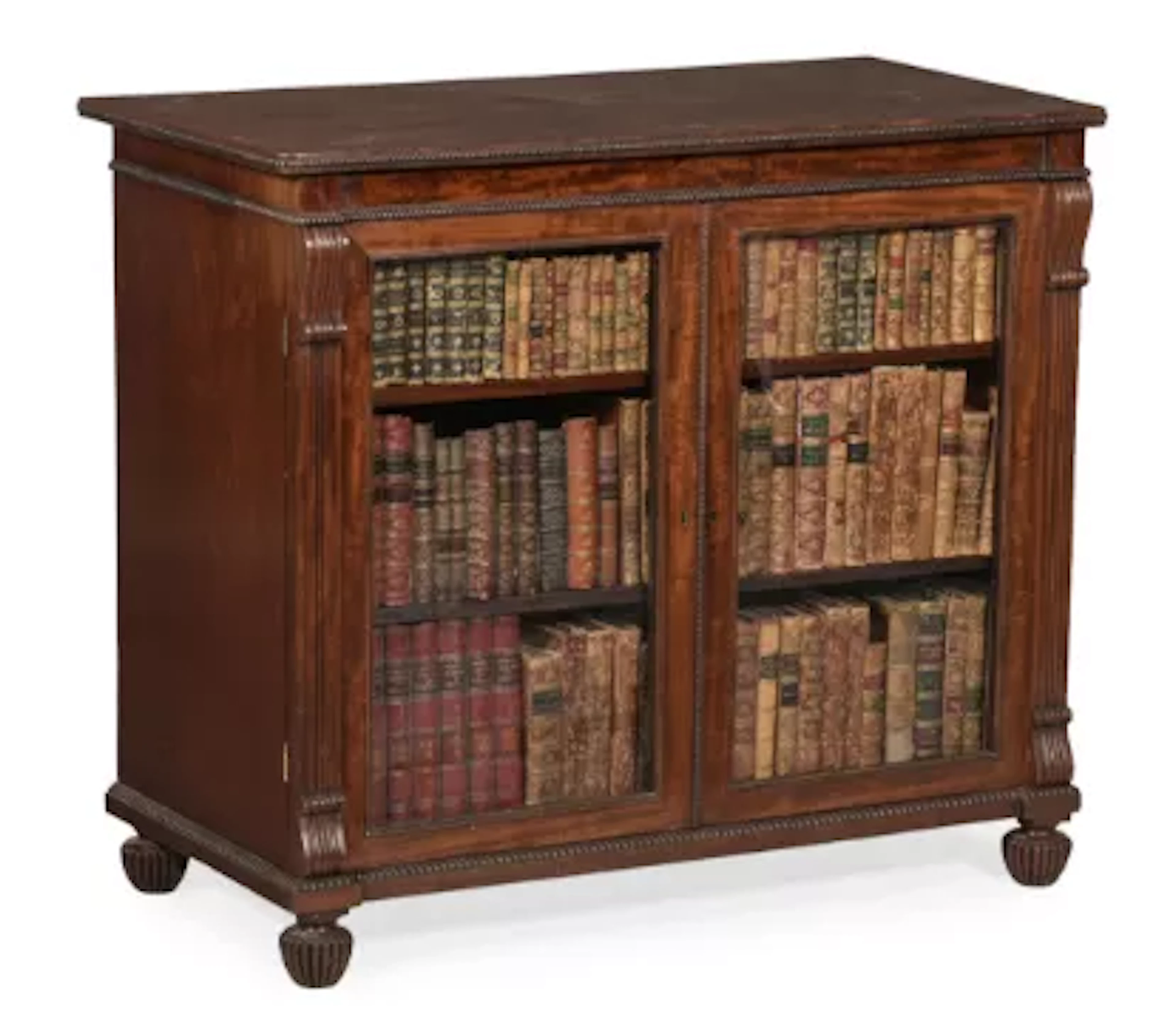 A REGENCY MAHOGANY BOOKCASE OR LIBRARY CABINET, ATTRIBUTED TO GILLOWS