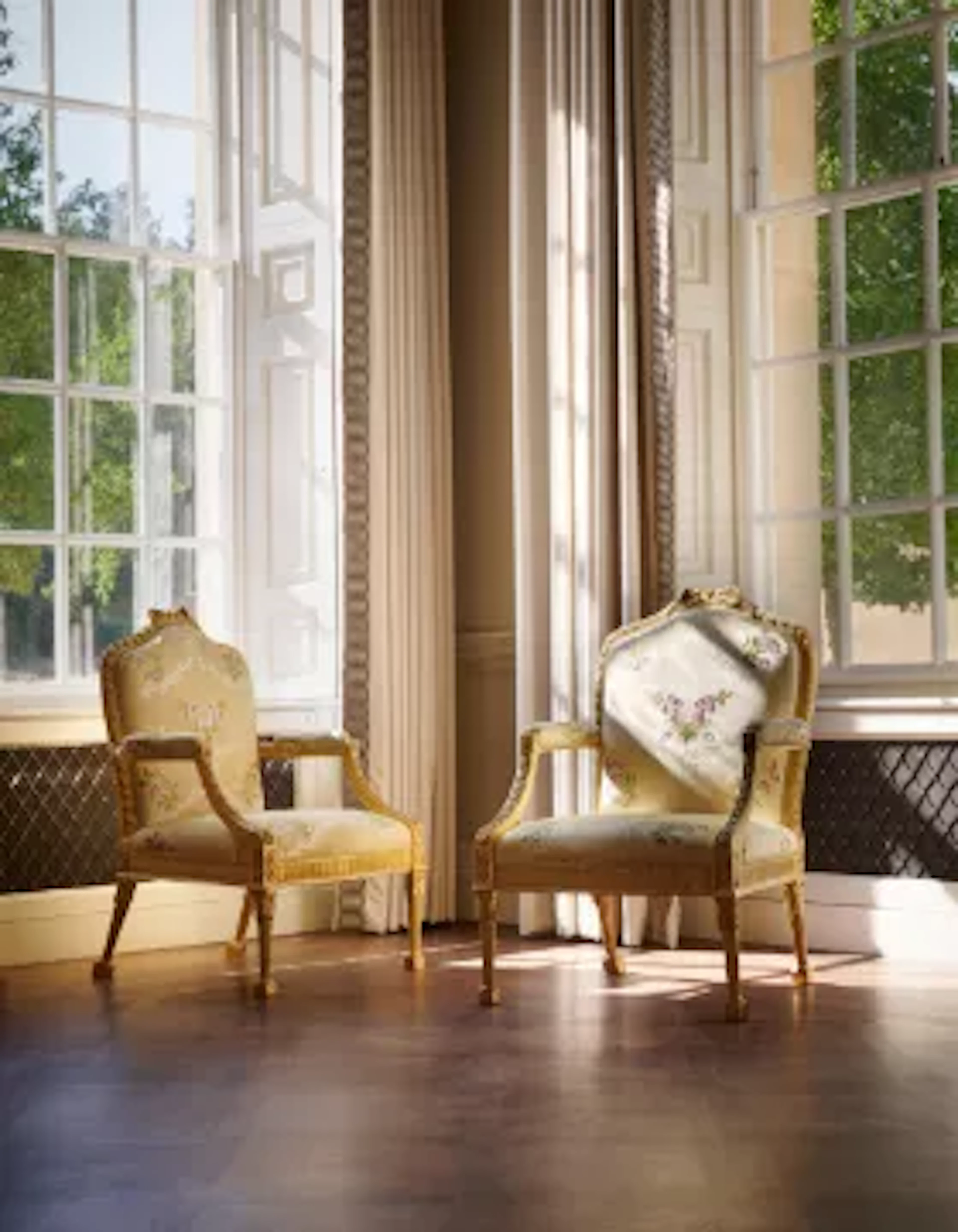 A SET OF FOUR GEORGE III GILTWOOD OPEN ARMCHAIRS, ATTRIBUTED TO JOHN