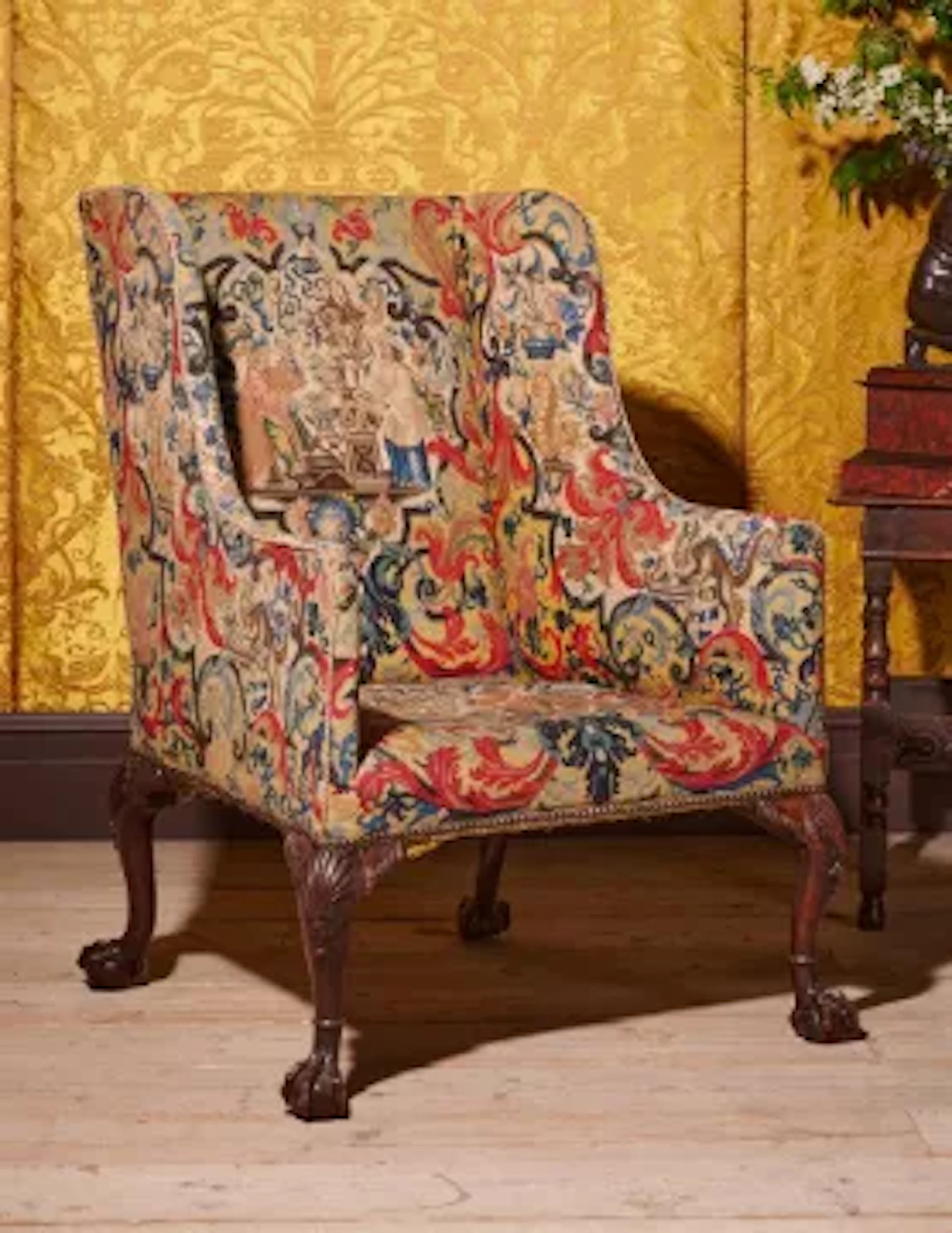 A FINE GEORGE II CARVED MAHOGANY AND NEEDLEWORK UPHOLSTERED WING ARMCHAIR