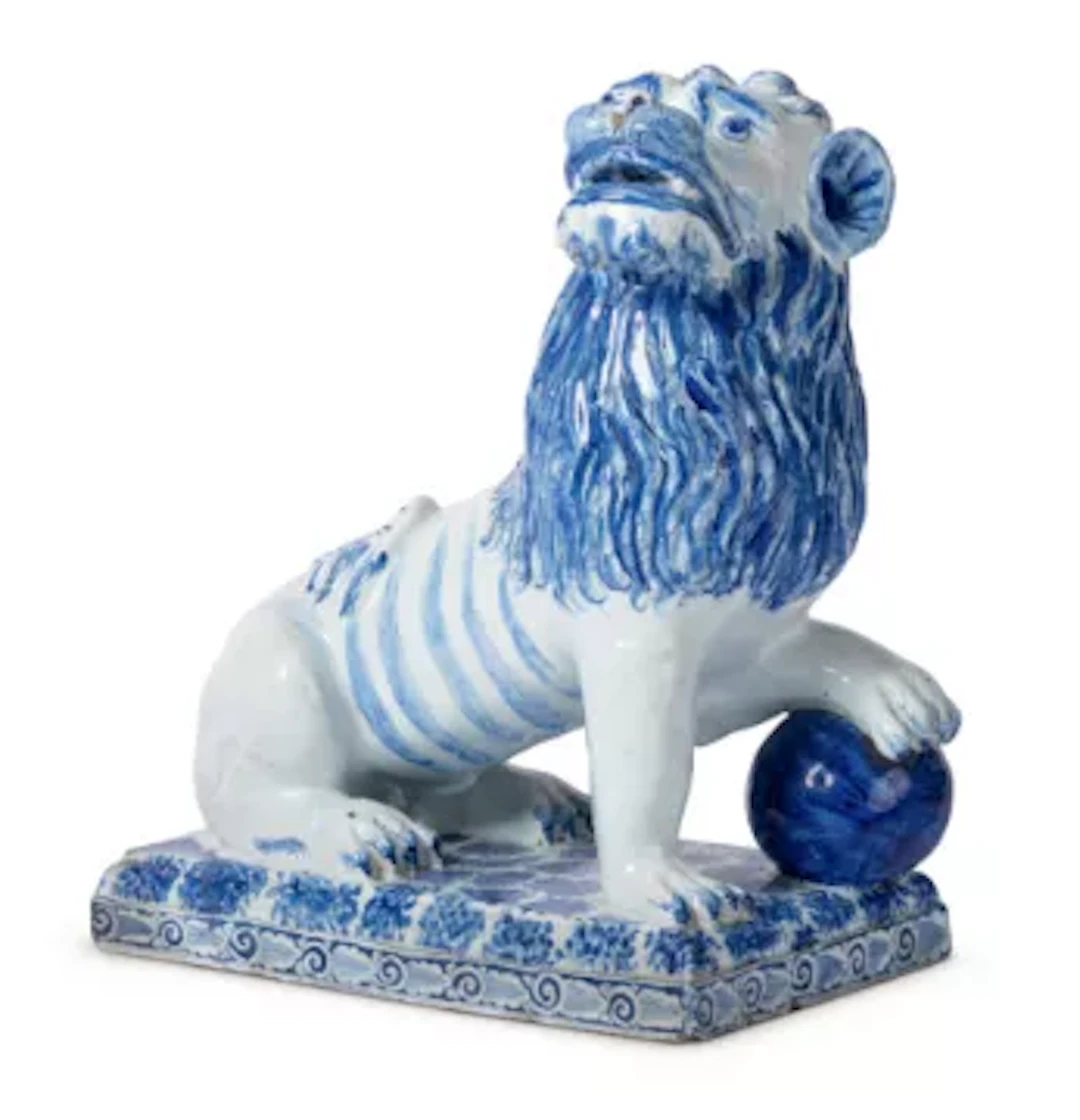 A LARGE FRENCH FAIENCE MODEL OF A SEATED LION, ROUEN OR LUNEVILLE, CIRCA 1800