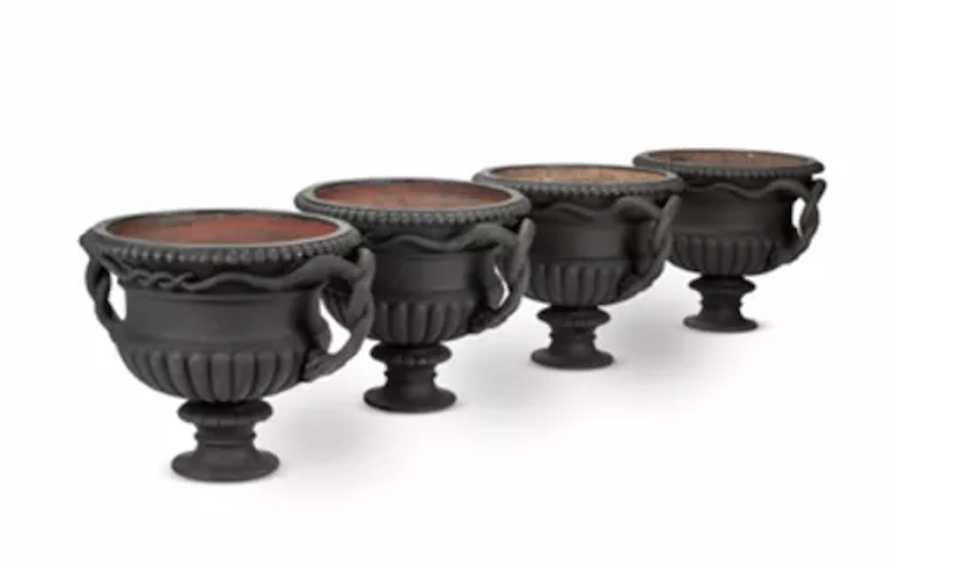 A RARE SET OF FOUR LARGE SNAKE HANDLED CAST IRON URNS, ATTRIBUTED