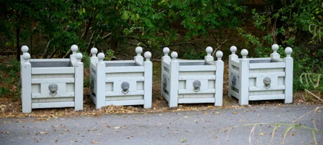 A SET OF FOUR GREY PAINTED TEAK AND BRASS MOUNTED RECTANGULAR PLANTERS