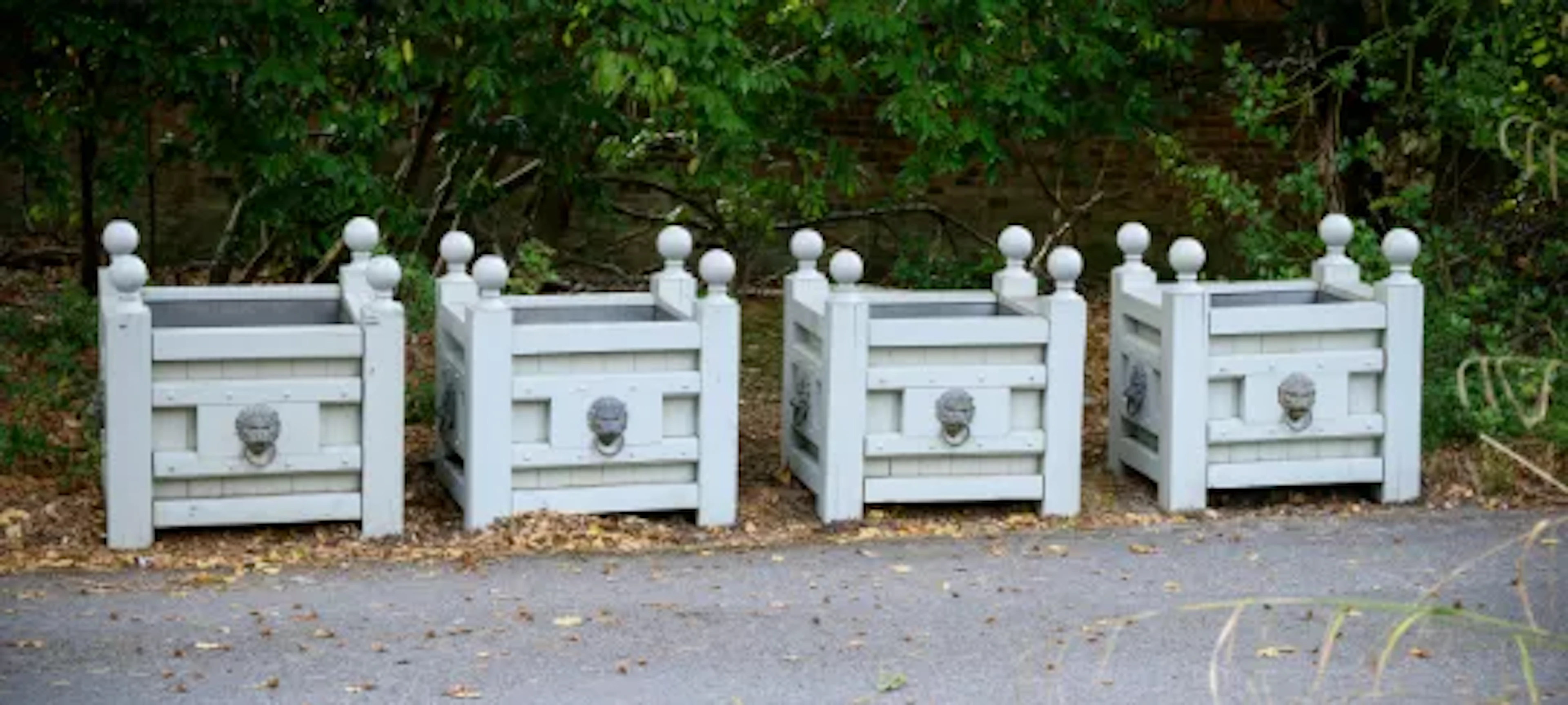 A SET OF FOUR GREY PAINTED TEAK AND BRASS MOUNTED RECTANGULAR PLANTERS