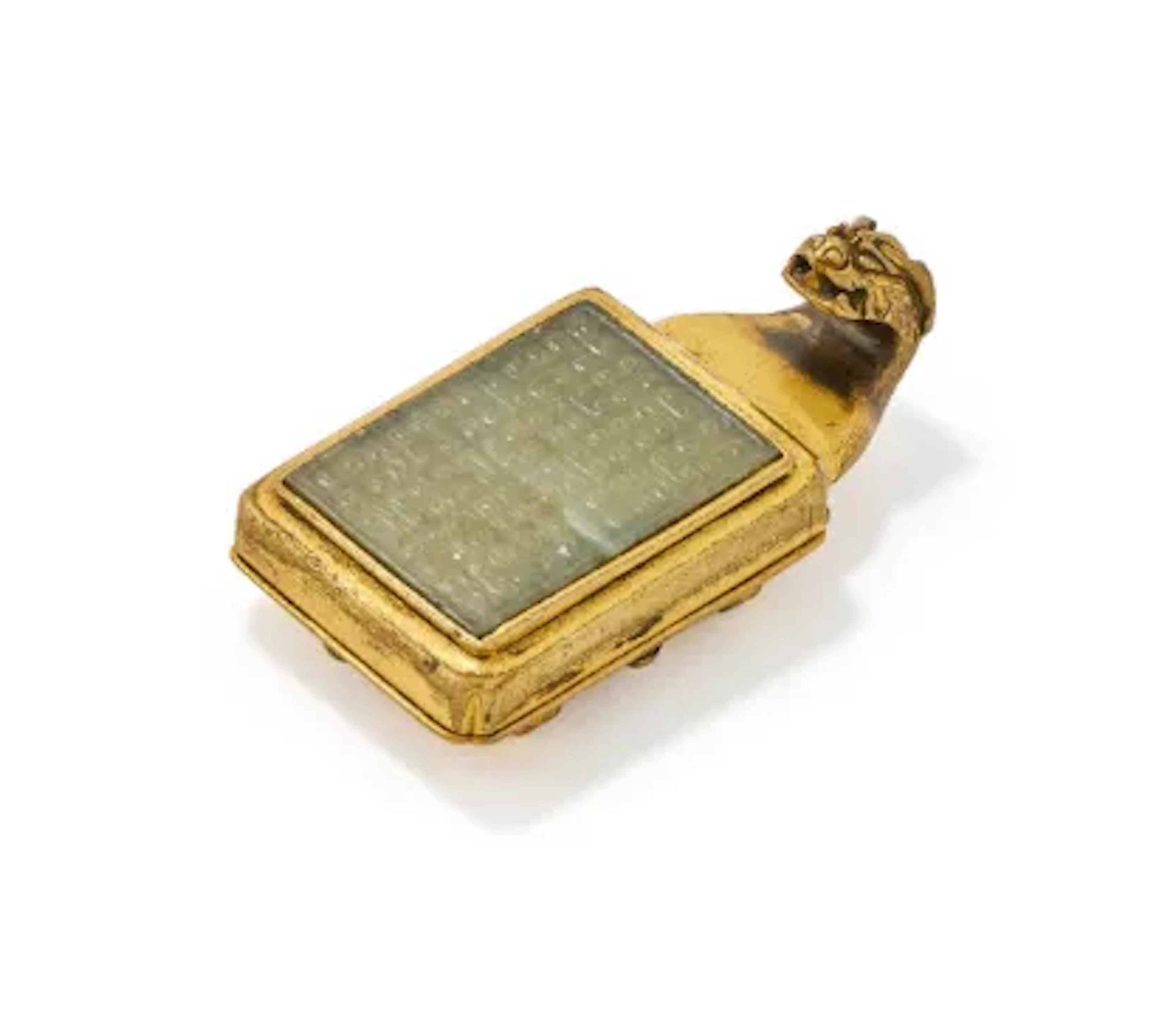 A gilt-bronze and celadon jade inlaid dragon belt buckle