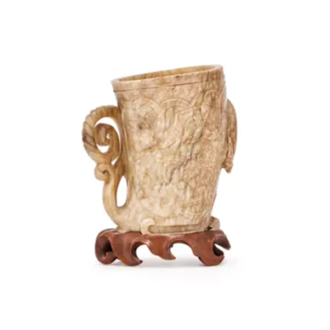 A Chinese pale celadon jade libation cup, Song or Ming Dynasty