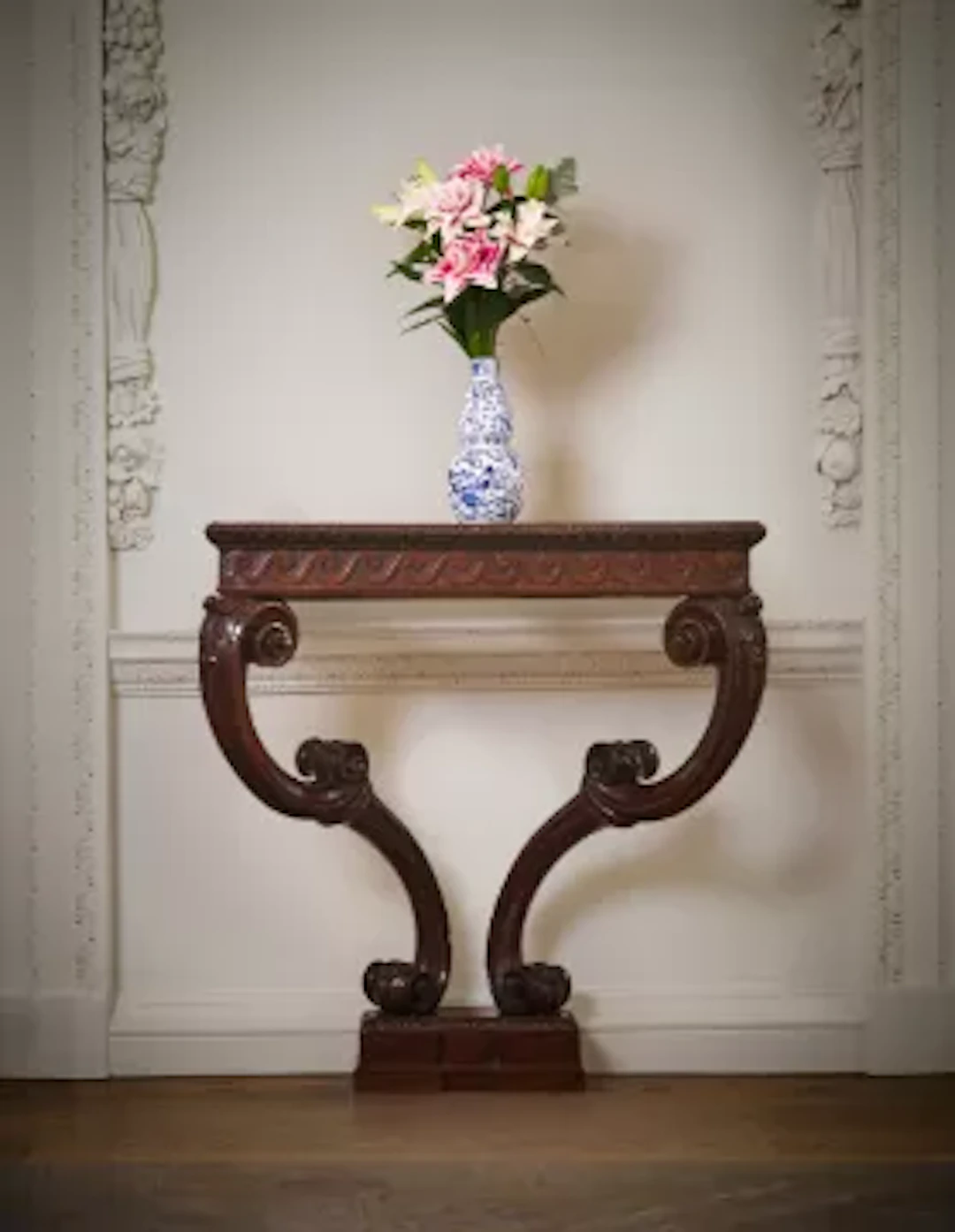 A GEORGE II CARVED MAHOGANY CONSOLE TABLE, IN THE MANNER OF WILLIAM