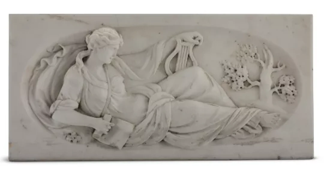 A CARVED MARBLE CHIMNEYPIECE TABLET OF THE MUSE OF MUSIC, 19TH CENTURY