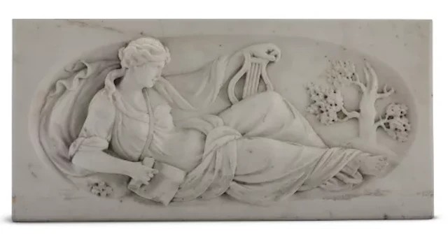 A CARVED MARBLE CHIMNEYPIECE TABLET OF THE MUSE OF MUSIC, 19TH CENTURY