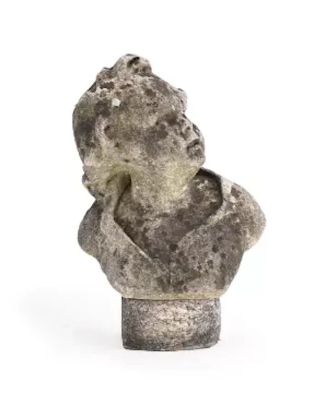 A WEATHERED CARVED MARBLE BUST OF A CHILD , PROBABLY LATE 18TH/EARLY
