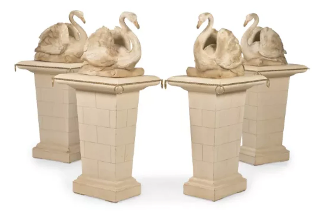 A SET OF FOUR CARVED WOOD AND PAINTED SWANS ON PEDESTALS, AFTER THE