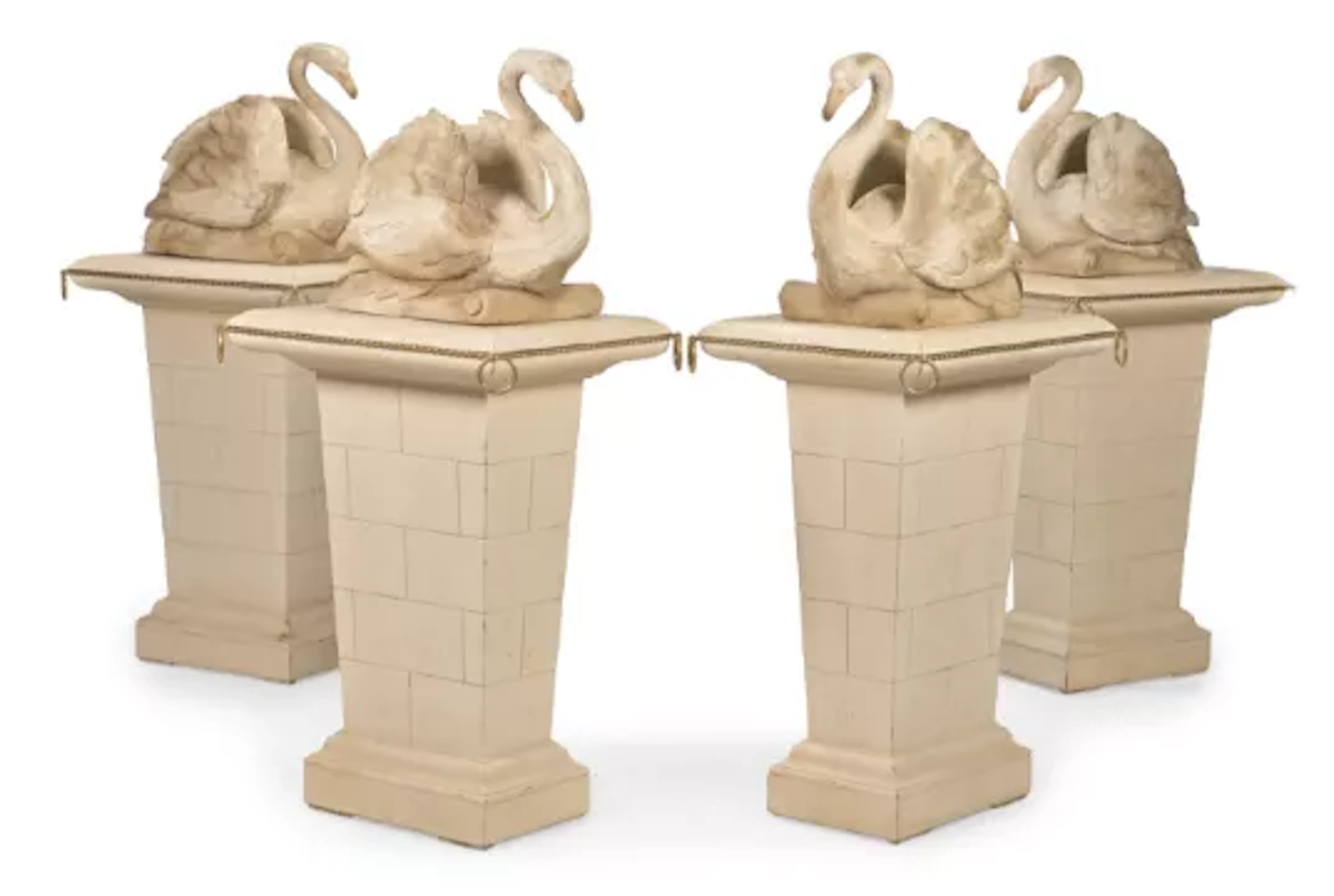 A SET OF FOUR CARVED WOOD AND PAINTED SWANS ON PEDESTALS, AFTER THE