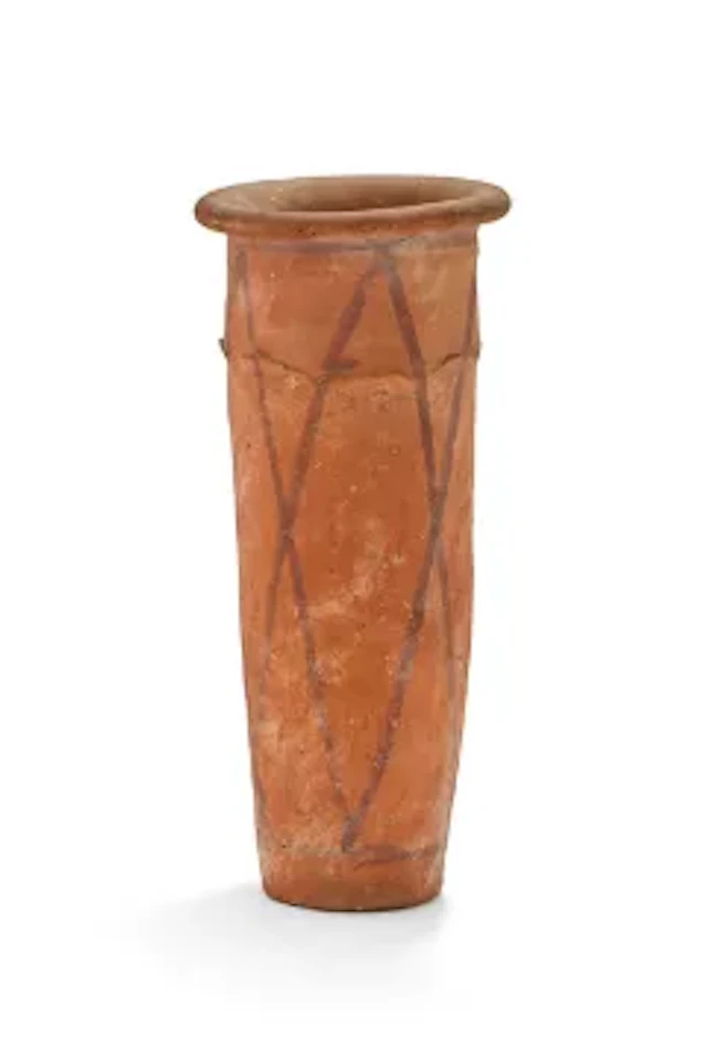 An Egyptian wavy-handled pottery jar, Predynastic Period, Naqada III