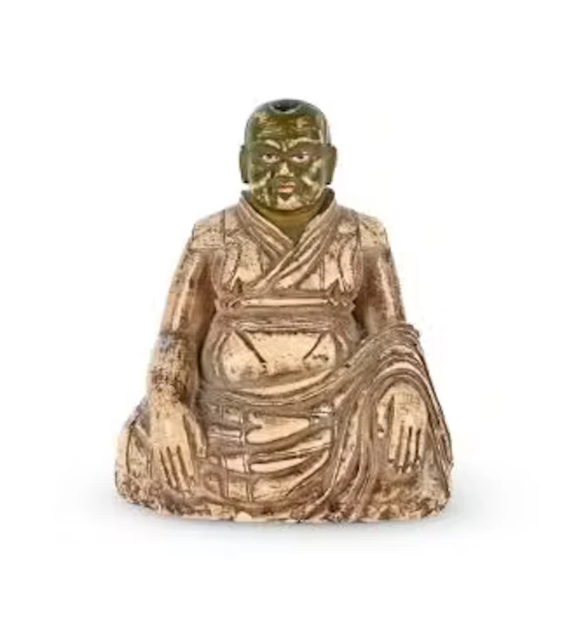 A Tibetan gilt and polychromed soapstone figure of a Lama