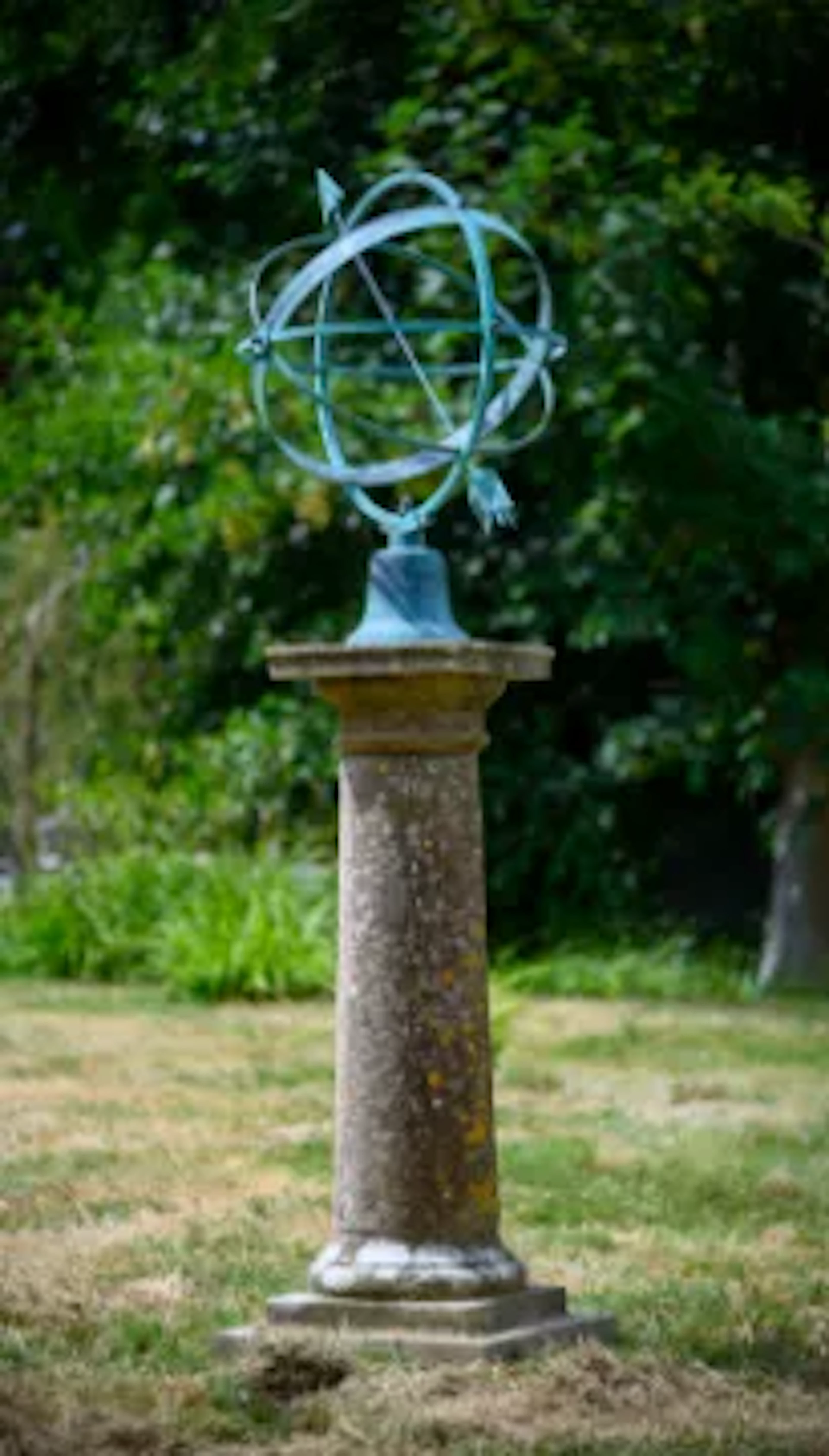 A VERDIGRIS BRONZE MOUNTED COMPOSITION STONE ARMILLARY SUNDIAL, 20TH CENTURY