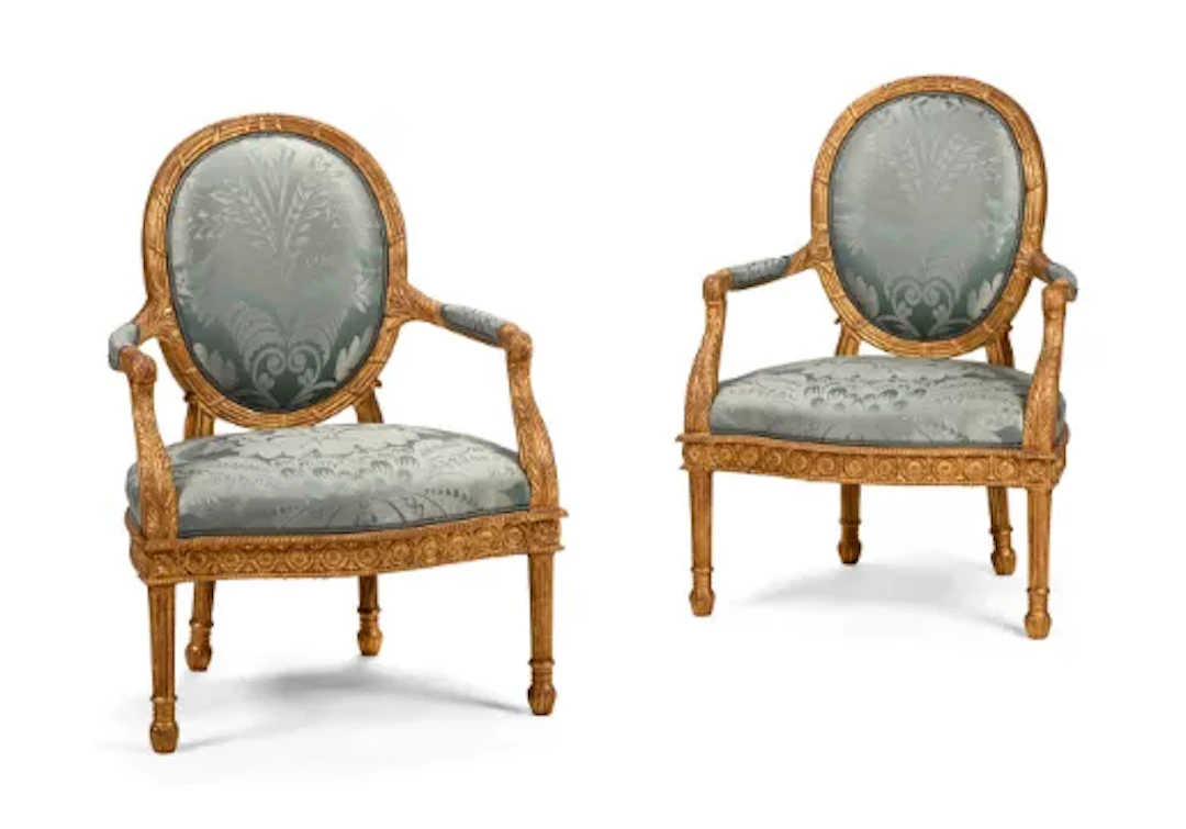 A PAIR OF CARVED GILTWOOD AND UPHOLSTERED ARMCHAIRS, AFTER A DESIGN