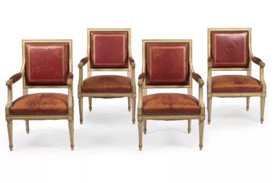 A SET OF FOUR PAINTED AND PARCEL GILT FAUTEUIL, IN LOUIS XVI STYLE