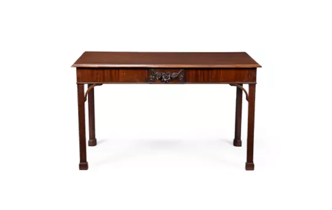 A GEORGE III CARVED MAHOGANY SERVING OR SIDE TABLE, IN THE MANNER