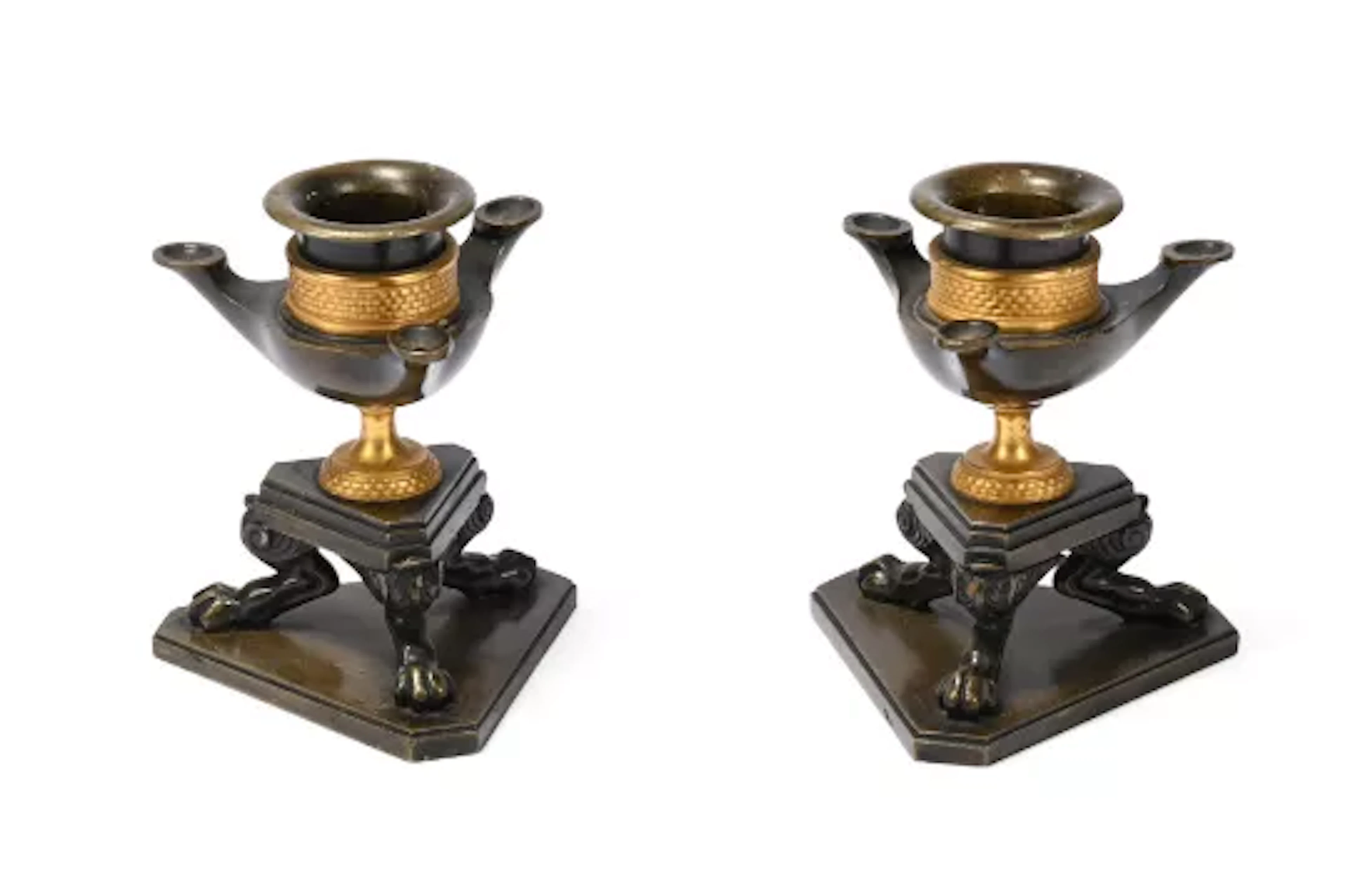 A PAIR OF REGENCY ORMOLU AND PATINATED CLASSICAL REVIVAL BRONZE CANDLESTICKS