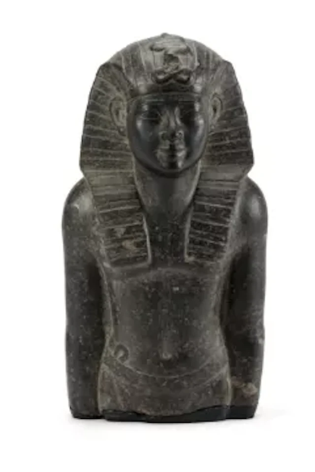 AFTER THE ANTIQUE, A CARVED BLACK GRANODIORITE HALF FIGURE OF A PHARAOH