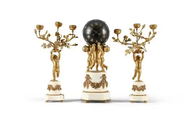 A FRENCH GILT AND PATINATED BRASS MOUNTED WHITE MARBLE MANTEL CLOCK GARNITURE