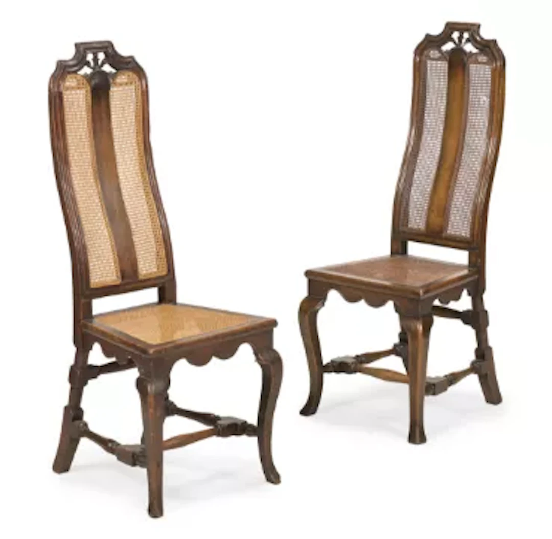 A PAIR OF WALNUT HIGH BACKED CHAIRS WITH SPLIT CANE PANELS, DUTCH, CIRCA 1700