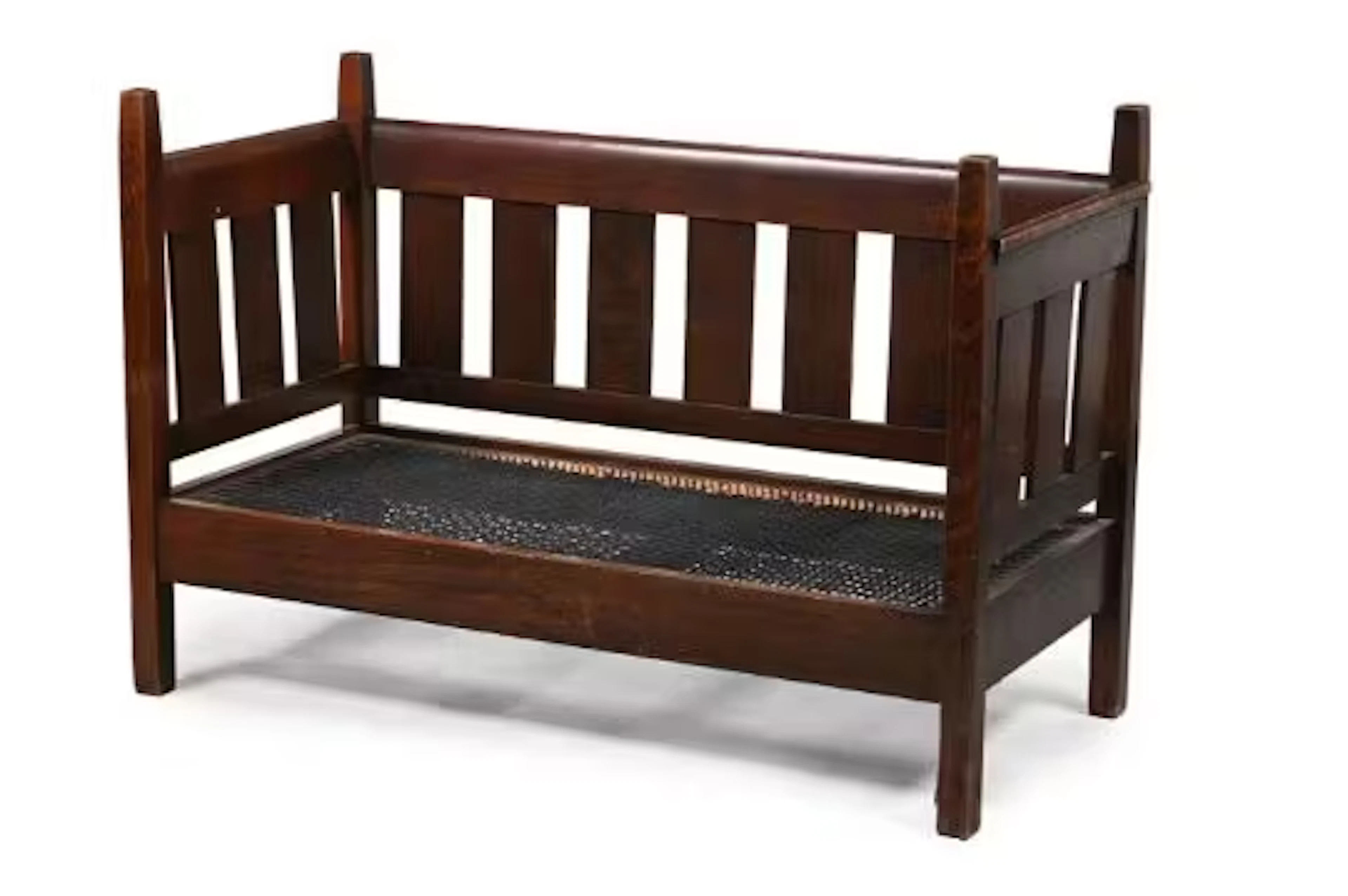 AN ARTS AND CRAFTS OAK SETTLE, POSSIBLY AMERICAN, IN THE MANNER OF