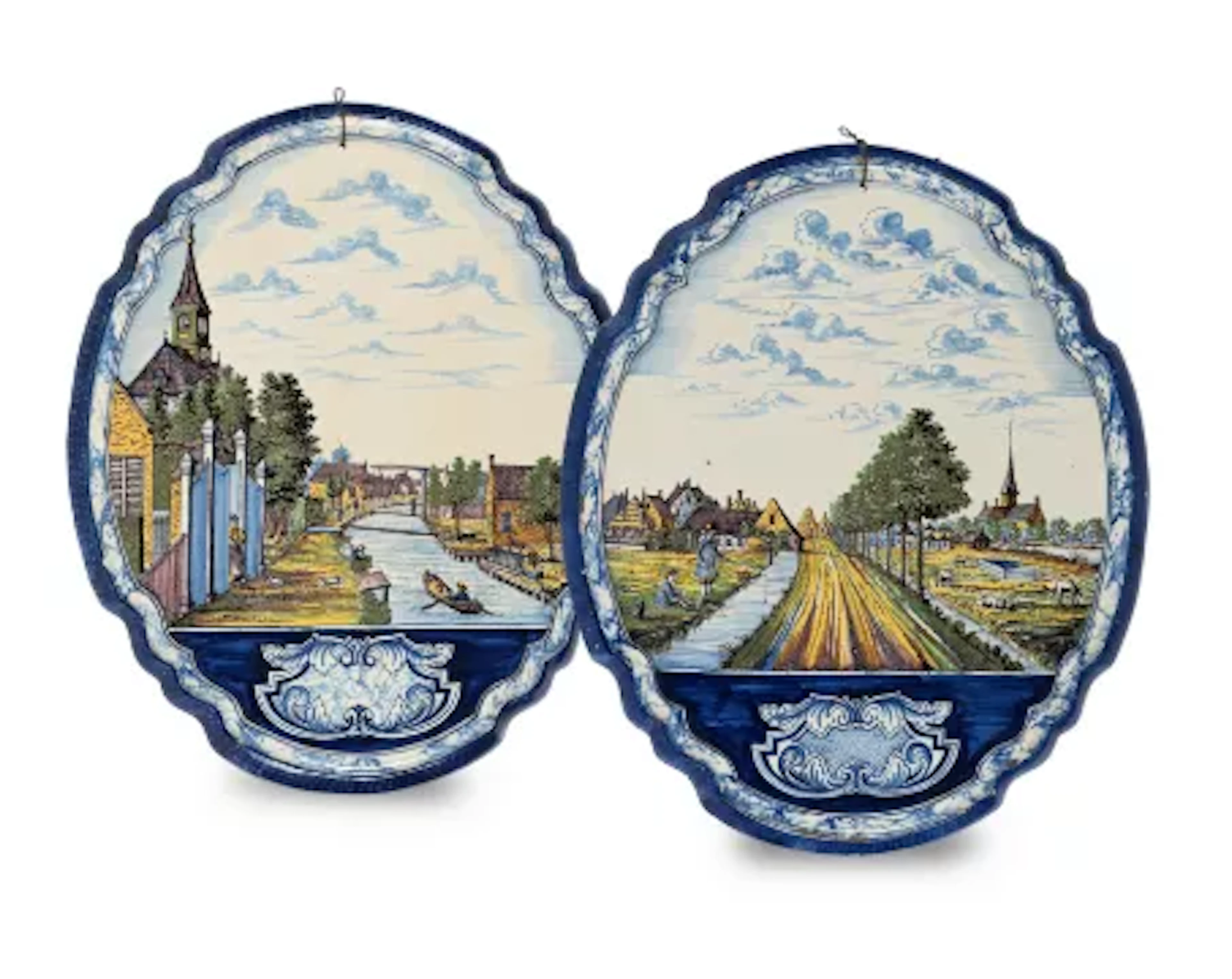 A PAIR OF DUTCH DELFT POLYCHROME SHAPED OVAL PLAQUES, LATE 19TH OR
