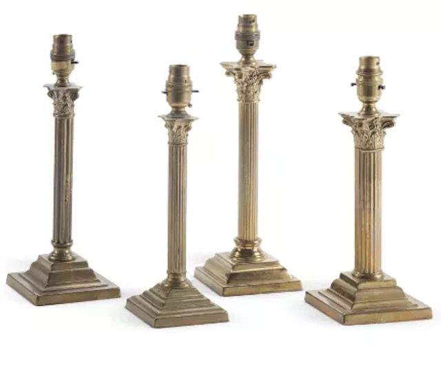 A GROUP OF FOUR POLISHED BRASS COLUMNAR TABLE LIGHTS, EARLY 20TH CENTURY