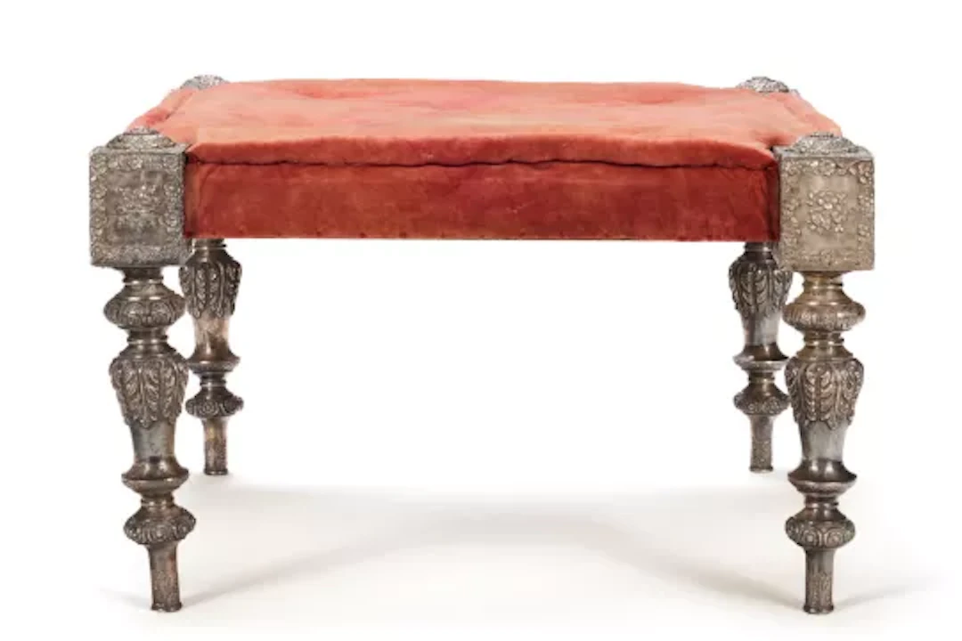 A RAJASTHANI RED VELVET UPHOLSTERED SILVER 'PALACE' STOOL OF LARGE SIZE