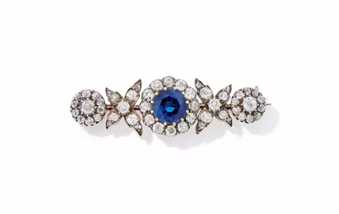 A LATE VICTORIAN AND LATER SAPPHIRE AND DIAMOND BROOCH
