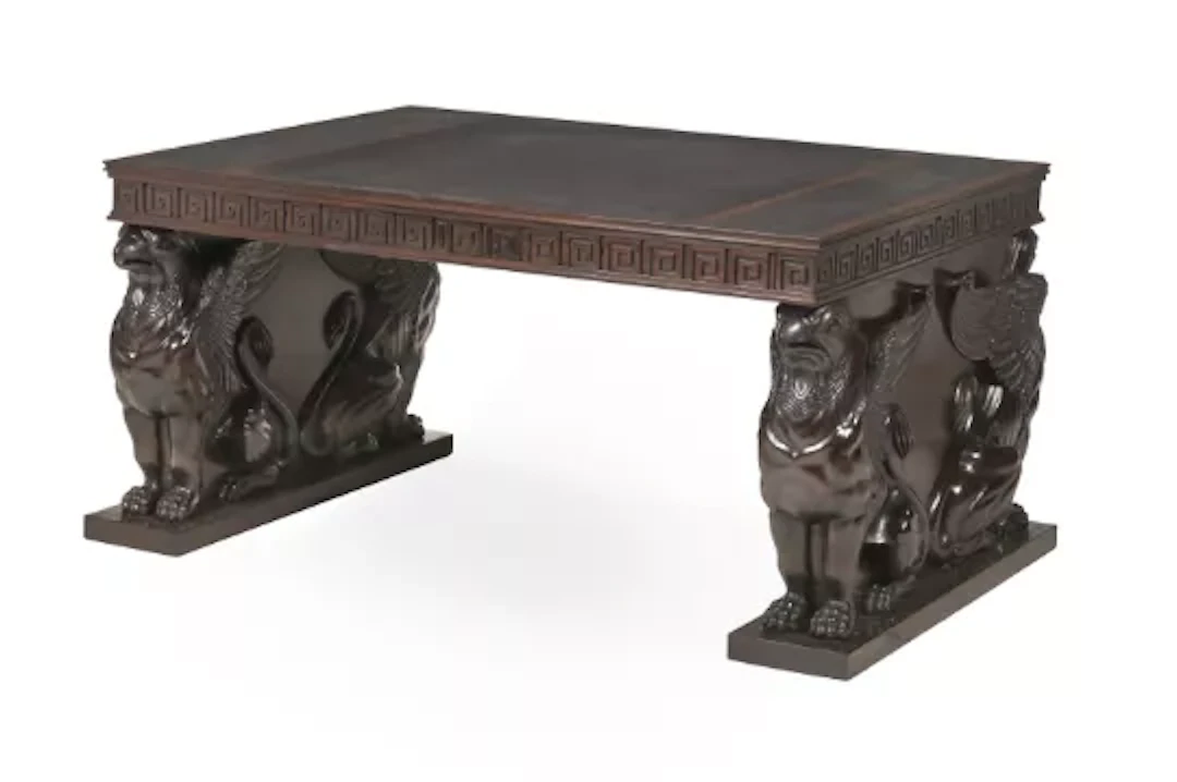 A CARVED MAHOGANY AND LEATHER INSET PEDESTAL DESK, IN REGENCY STYLE