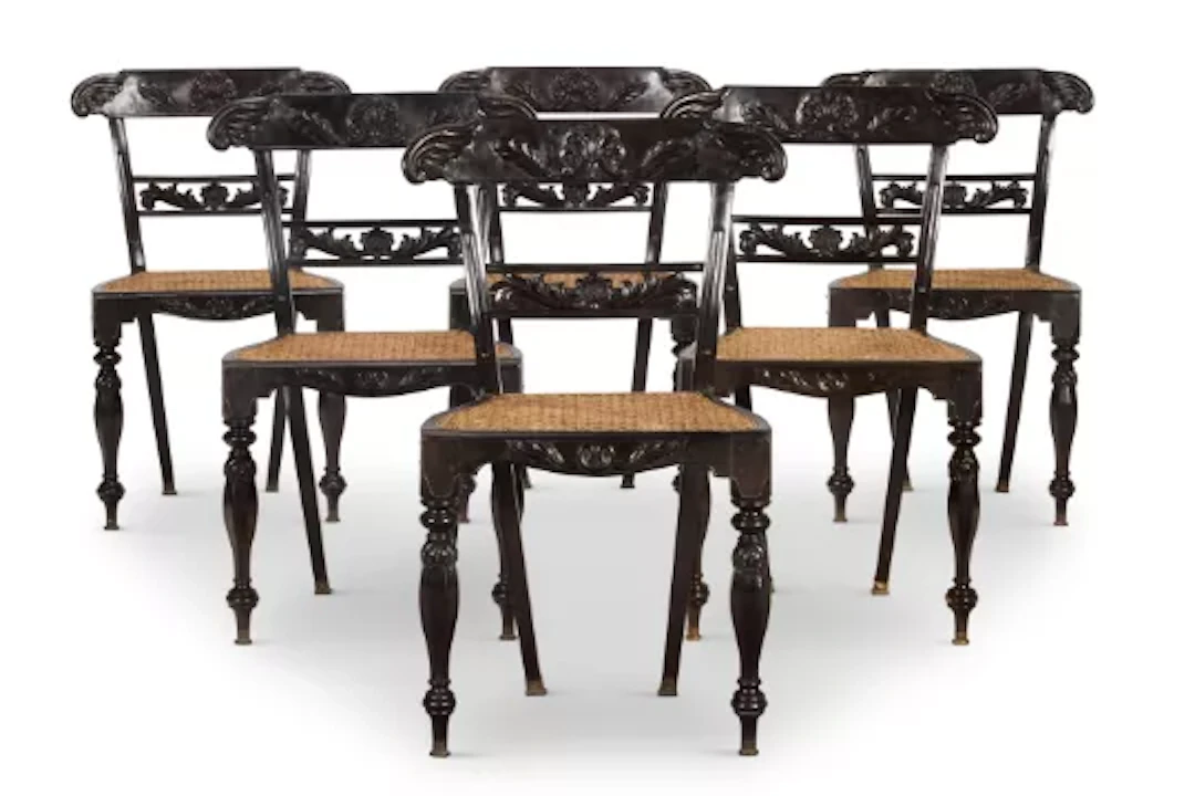 Y A SET OF SIX CEYLONESE CARVED EBONY AND CANED CHAIRS, SECOND HALF