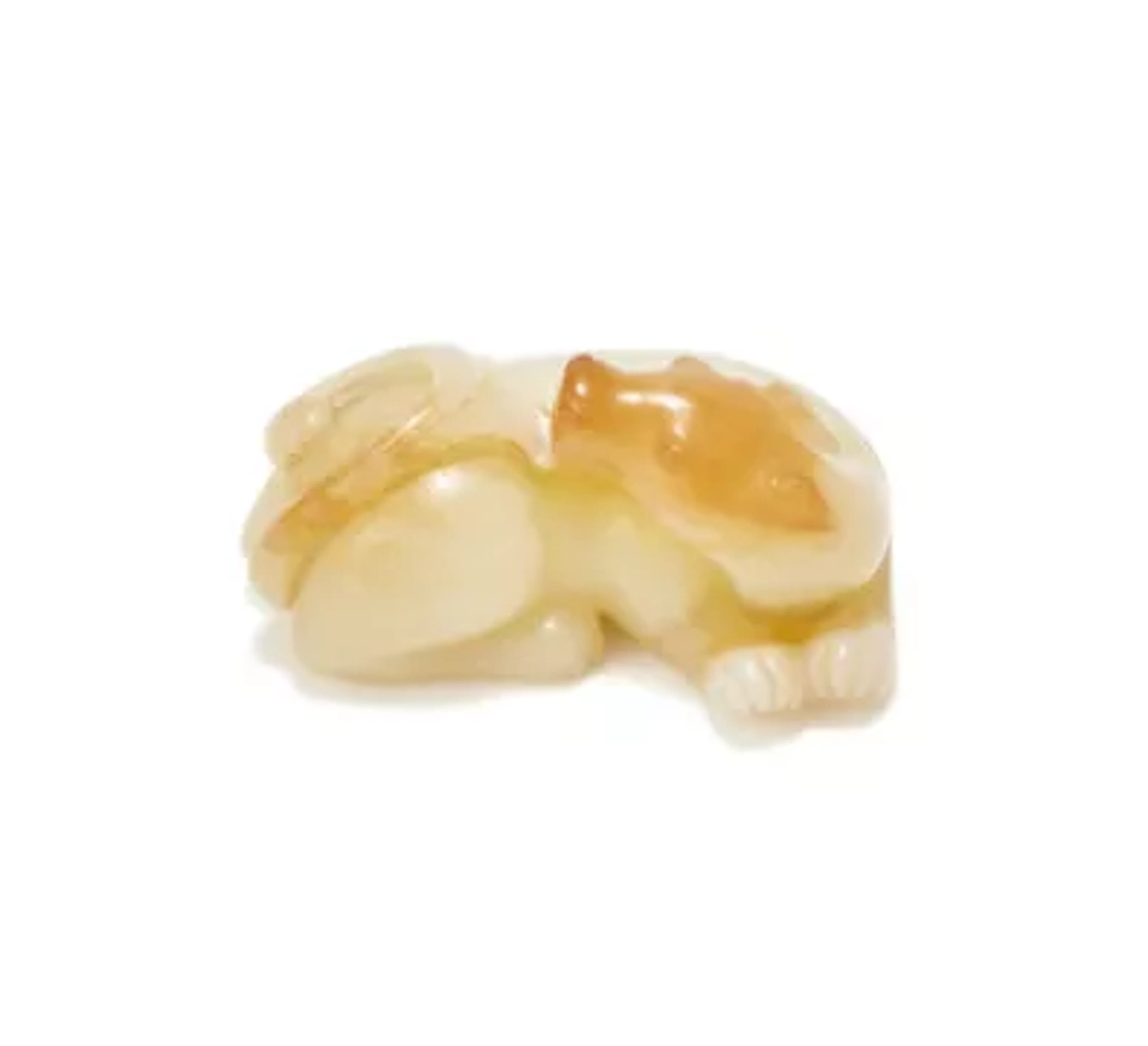 A Chinese white and russet jade carving of a recumbent beast, Qing Dynasty