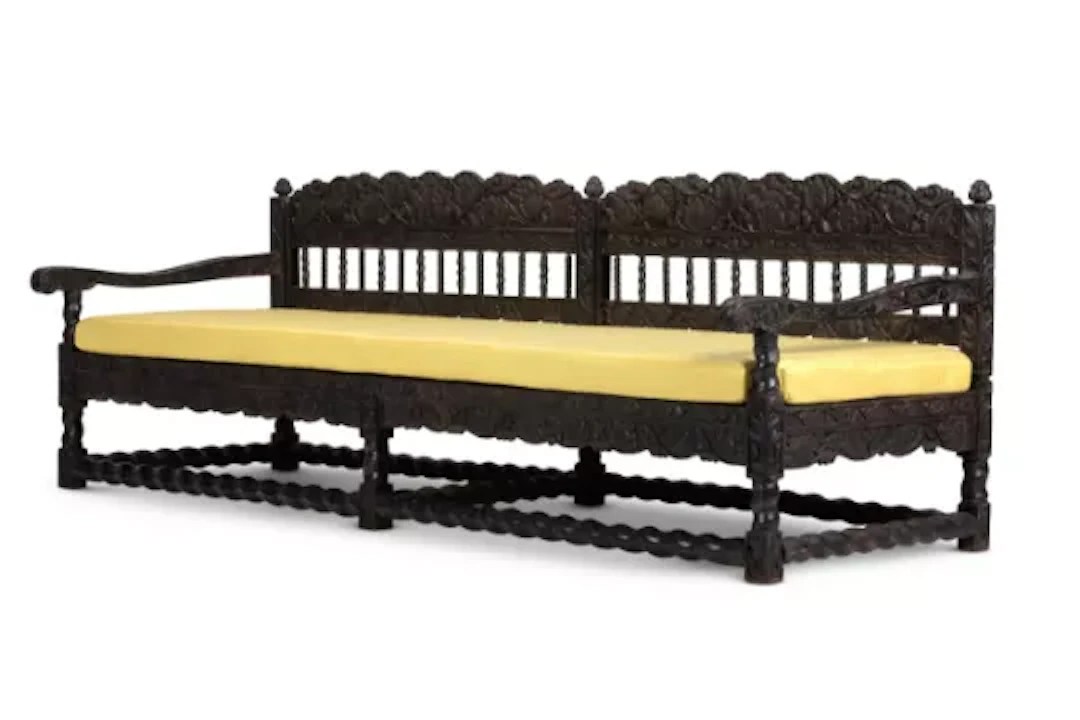 A LARGE COROMANDEL COAST CARVED AND EBONISED HARDWOOD SOFA, INDIAN