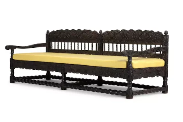 A LARGE COROMANDEL COAST CARVED AND EBONISED HARDWOOD SOFA, INDIAN